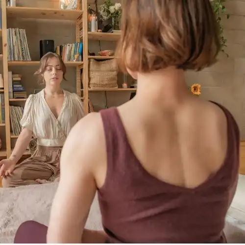 Student meditating with a teacher during Reiki training